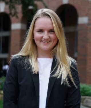 Headshot of Mary Spain Lowder in front of university building